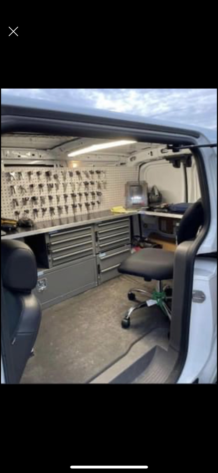 Organized locksmith workshop with keys and tools